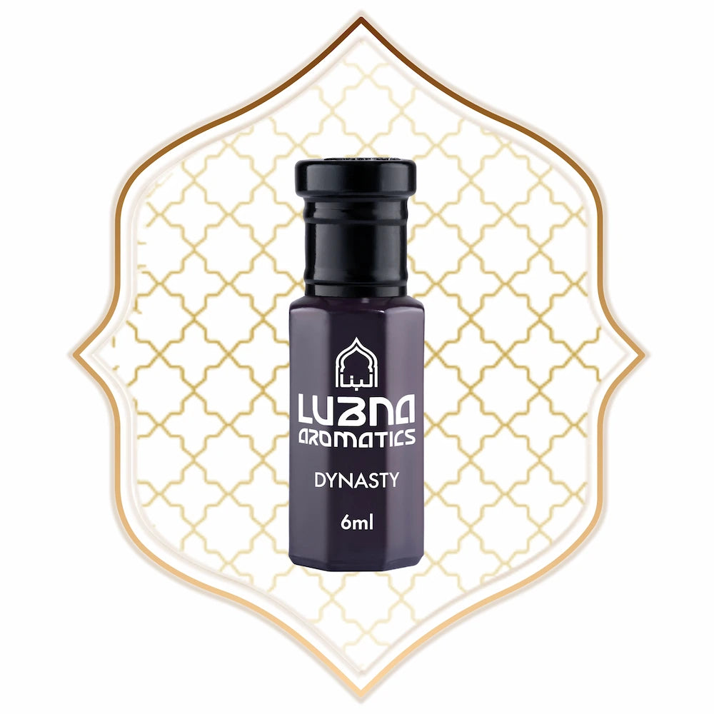 Small purple bottle with black cap labeled 'Luzano Aromatics Dynasty' on a decorative white and gold background.